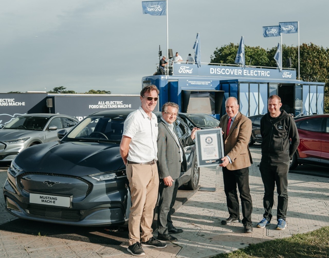 Ford's Tim Nicklin receives record certificate from left to right Mustang Mach-E drivers Fergal McGrath Paul Clifton and Kevin Booker  1
