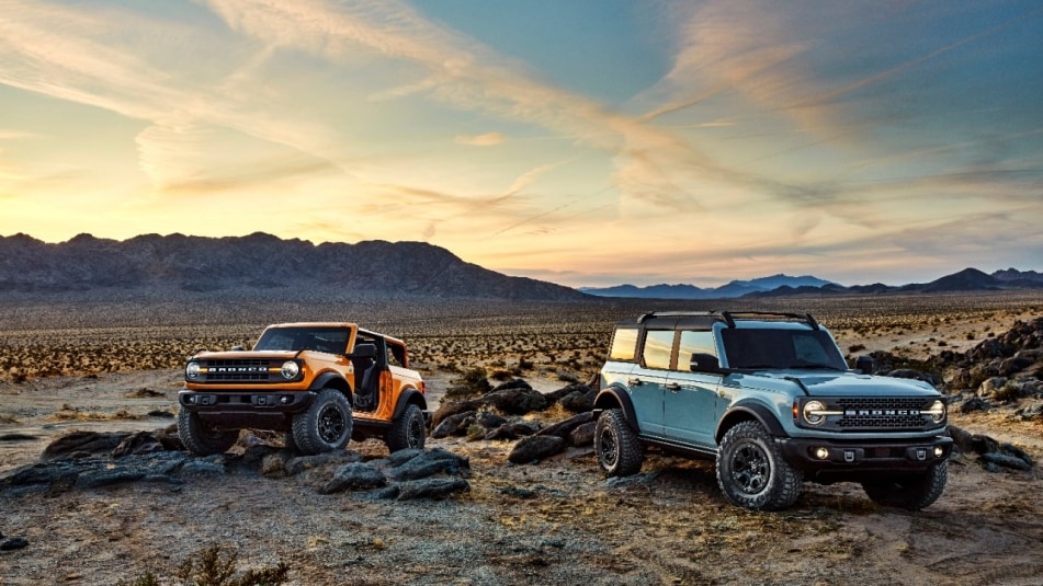 Pre-production versions of the 2021 Bronco, shown here, include Bronco two-door in Cyber Orange Metallic Tri-Coat and Bronco four-door in Cactus Gray.
